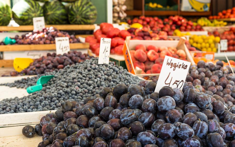 Plums on the market stand in Poland with a price sign reading 4 50