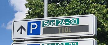 Road sign pointing towards the parking garages where people can park for TOOL concert