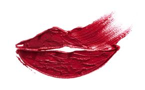 A textured smear of red lipstick on white paper in the shape of lips 