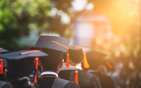 Photo Of Rear view of Graduates join the graduation ceremony.