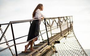 a beautiful girl in a pirate costume on the deck of a ship