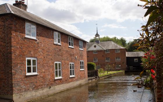 Test River with the Whitchurch Silk Mill on the left. Hampshire, England, UK