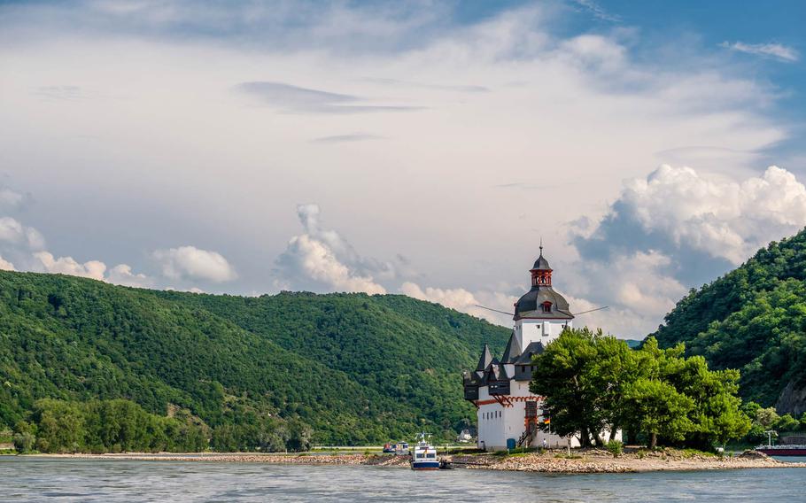 Ferry approaching Burg Pfalzgrafenstein, a historic toll castle on Falkenau Island in the Rhine River.