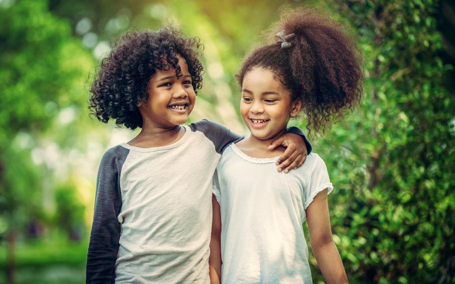 Two  children together in the garden.