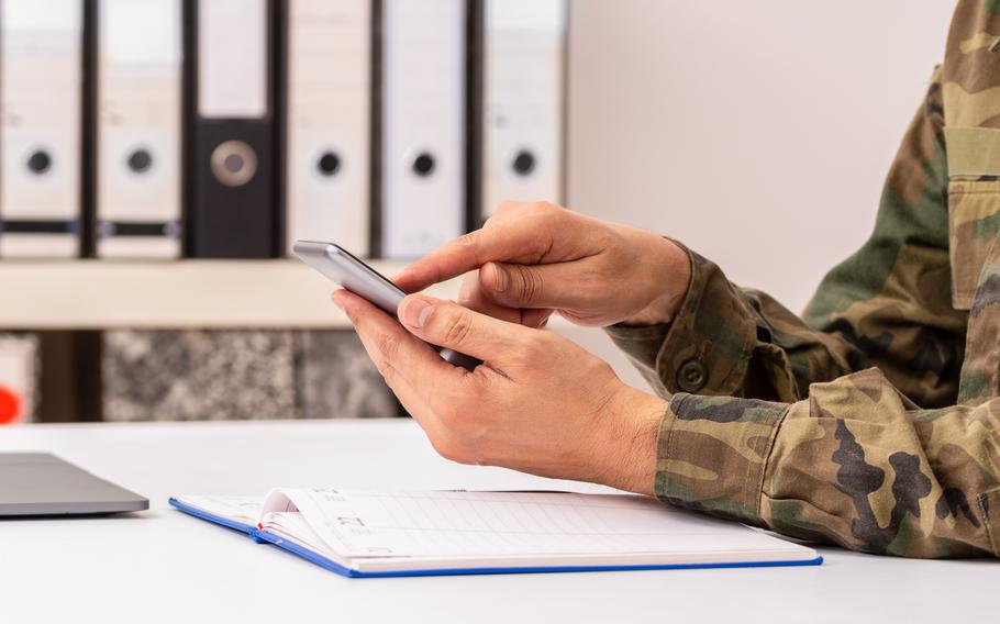 person in uniform with a phone