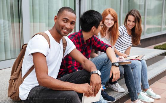 Diverse group of college students sitting on the stairs.