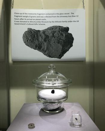 Fragment of meteorite in clear case at the museum