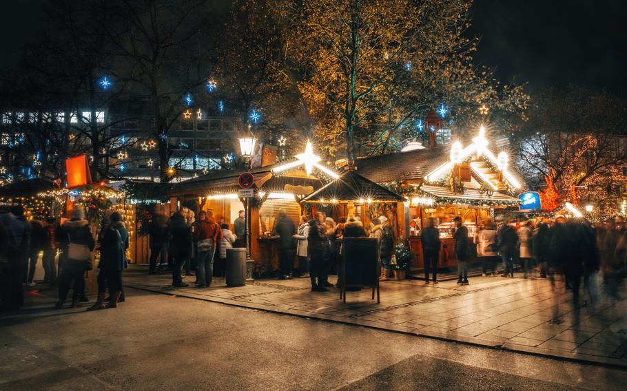 Crowded traditional christmas market at night with illumination 