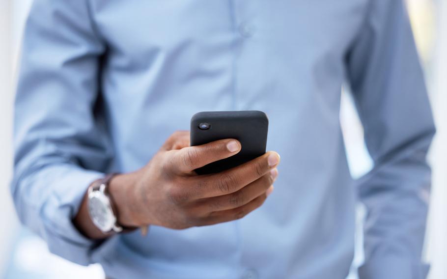 Cropped shot of a businessman using his cellphone.