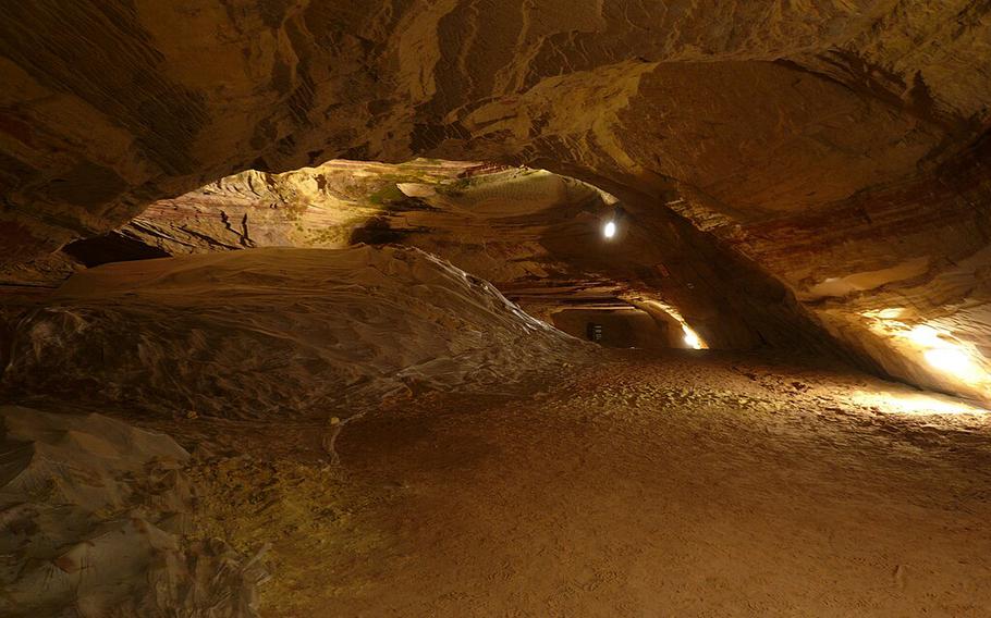 light illuminates red and brown sandstone caves