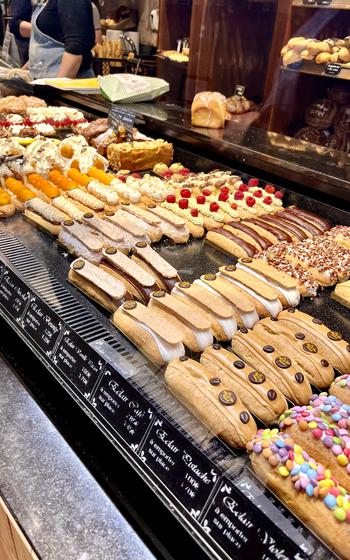 colorful picture of chocolate eclairs in a bakery