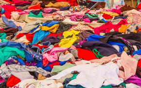 Large pile of clothes layed out on a table