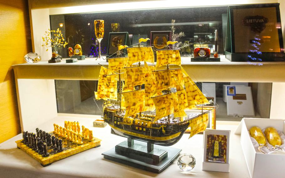 a sailboat with the sails made from amber
