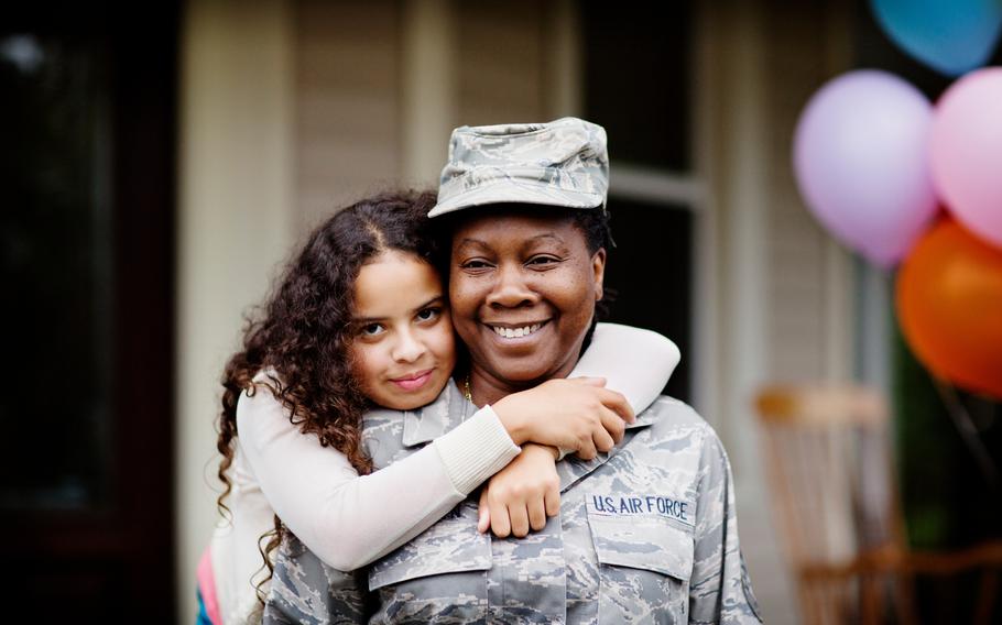 Daughter hugging her Military Mother outdoors