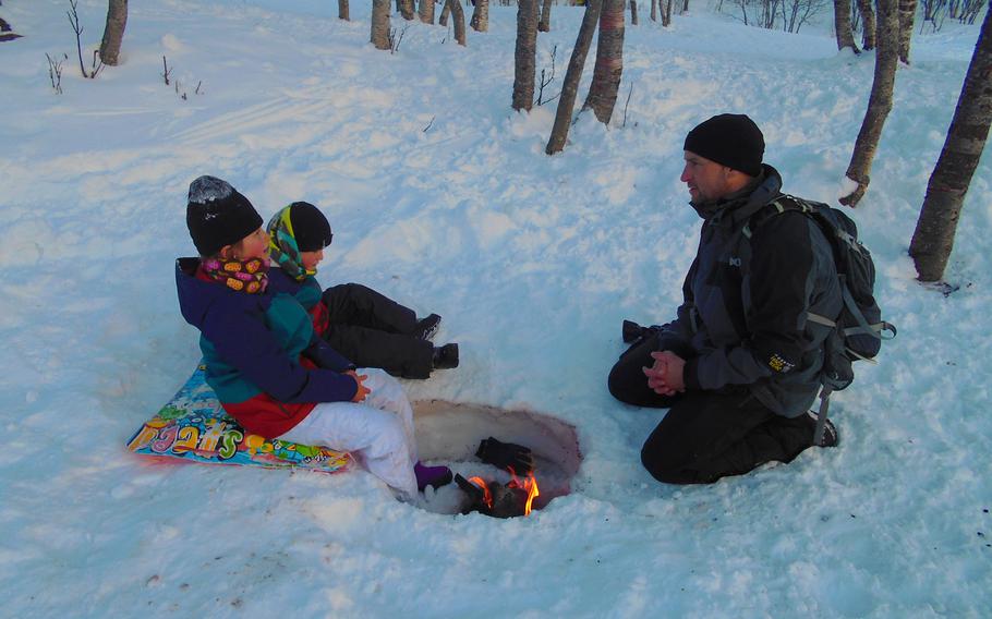 firepit for feet while sledding , Norway