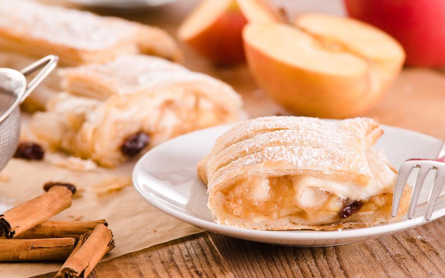 Apple strudel on a white plate with silver fork
