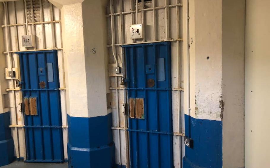 Blue jail doors behind bars