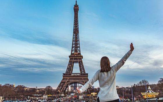 Young girl on vacation in paris with the Eiffel tower in the background