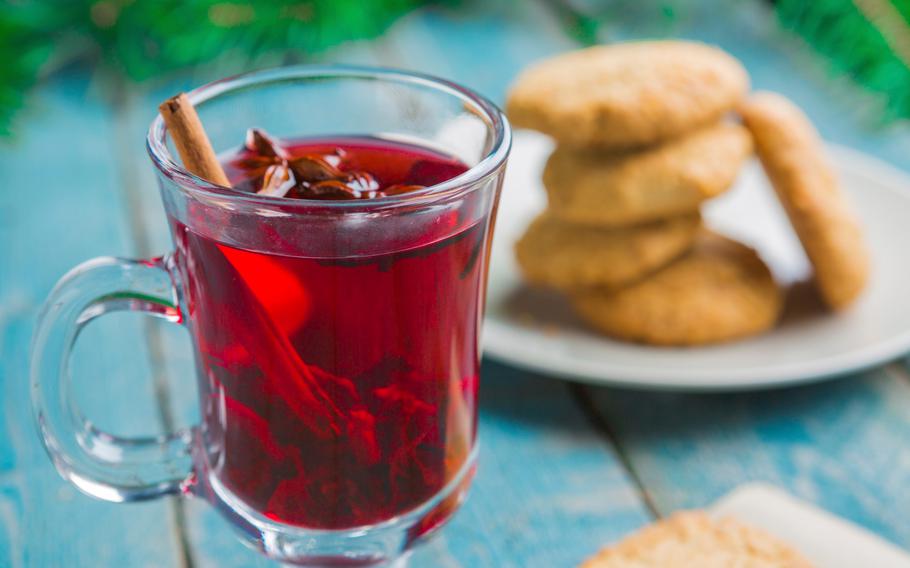 Christmas Mulled Wine with cookies Decorated with Fir Branches on wooden background