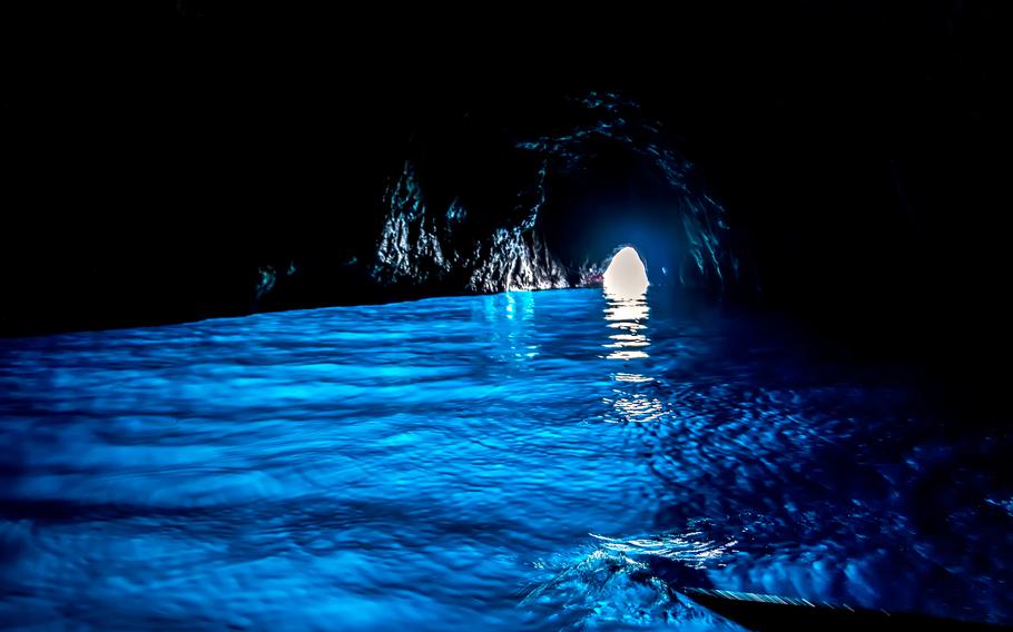 a dark blue cave with light blue water
