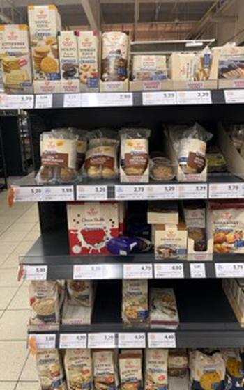 a picture of various Hammermuhle products like bread and cereal on shelves. 