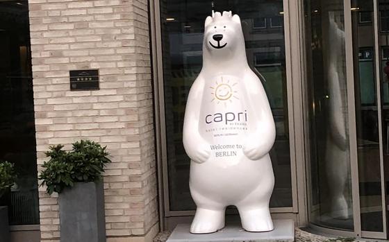 Photo Of White bear statue in front of hotel, bear’s torso reads “Capri”