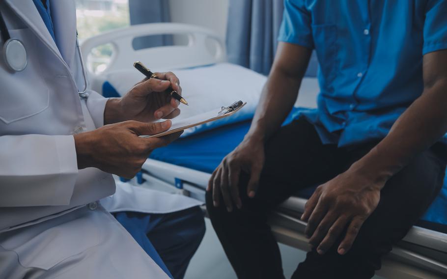 Doctor and patient discussing perfect health exam results. 