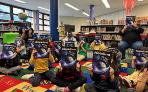 Second-grade class at Ramstein Elementary School library reading the newest “Dandelions” magazine.