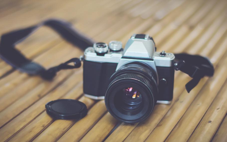 Retro camera on bamboo table