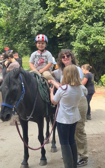 Child on a horse looking at the camera