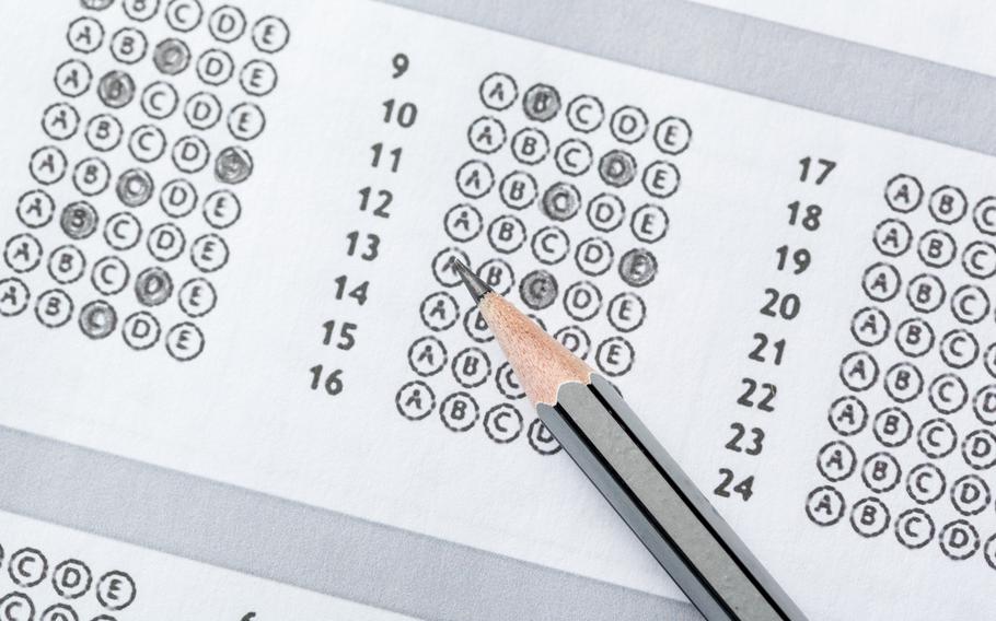 Test score sheet with answers and pencil, closeup of test score sheet