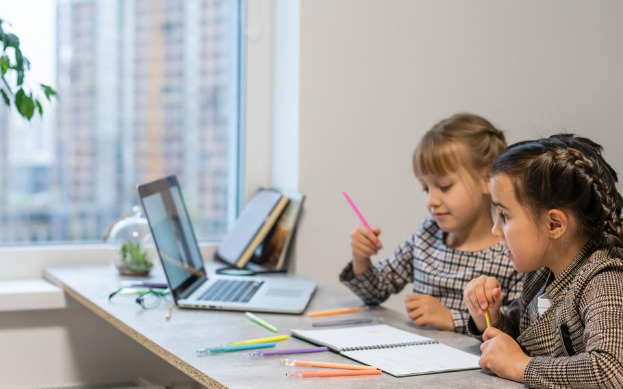 Two little girls doing their school homework