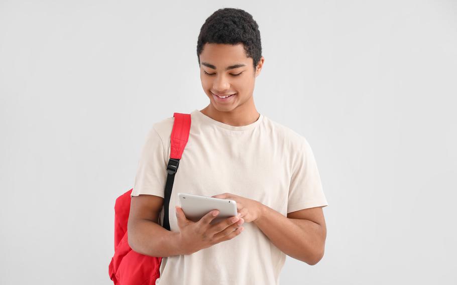 Student taking notes on his tablet