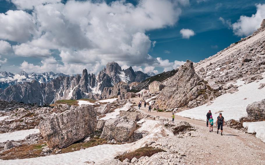 People on a trail near the three peaks in the Dolomites, Italy