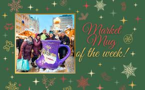 A group of women circled around a giant, bright purple boot-shaped mug a the Christmas market. 