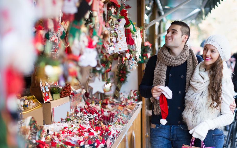 Man and women shopping at Christmas market