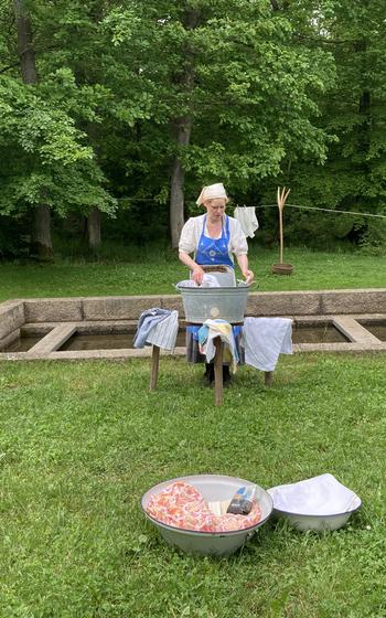 A washerwoman shows her skill at the Hessenpark in Germany.