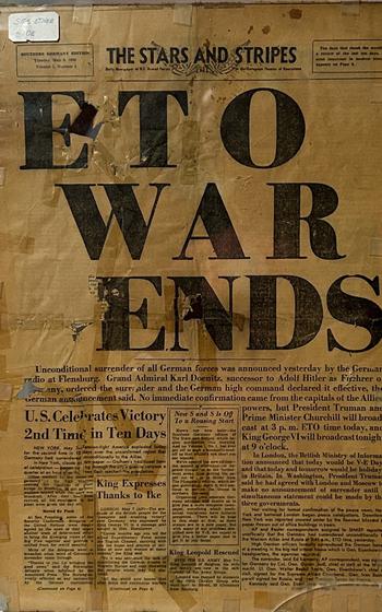 a yellowed newspaper clipping announcing the end of WWII