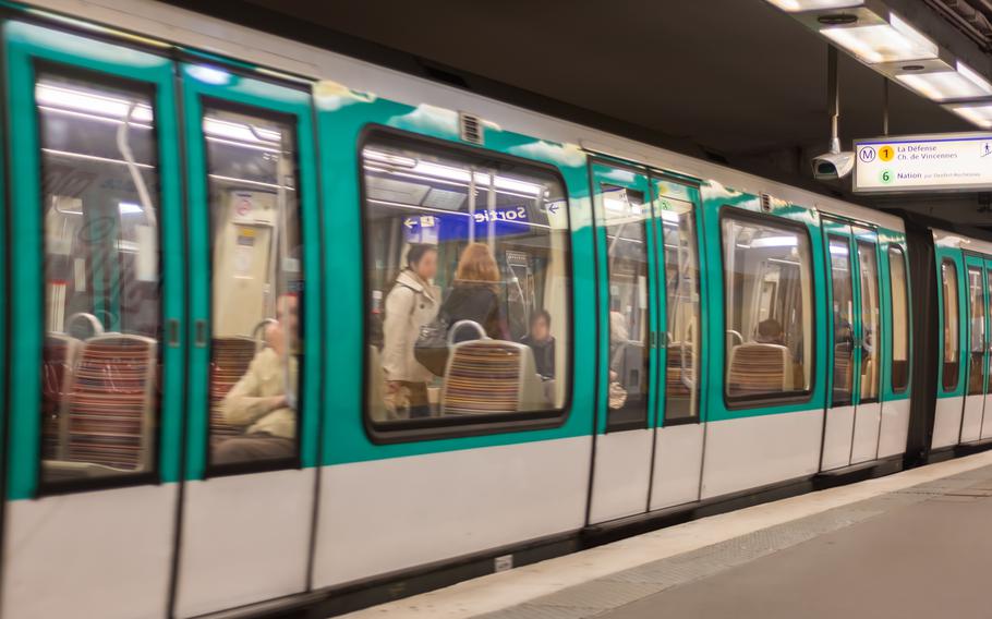 A white and green Paris underground Metro train.