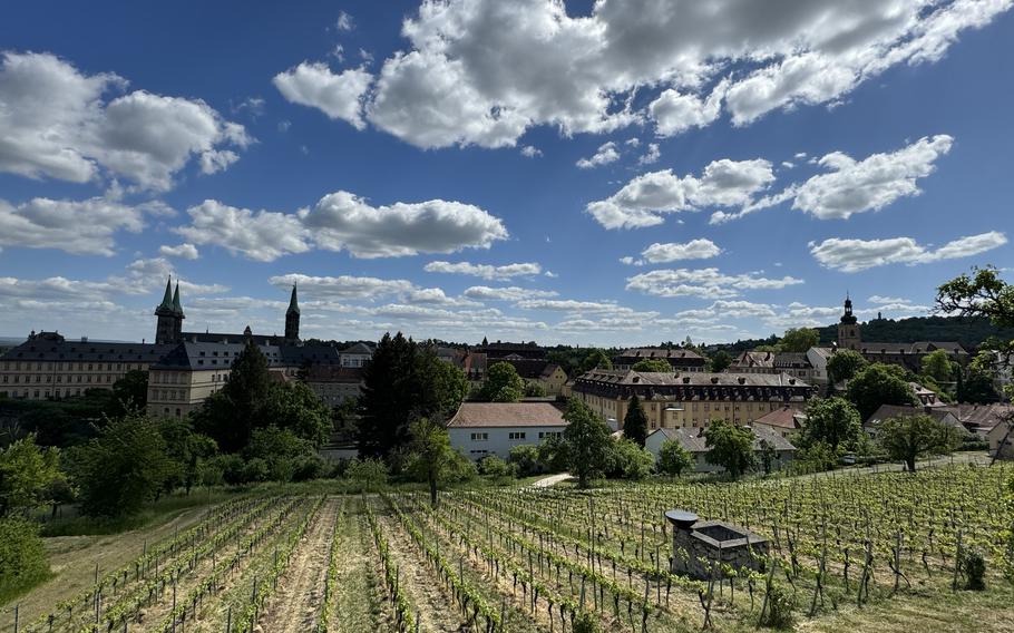 bright clouds and green wine fields leading to a view of Bamberg’s old town