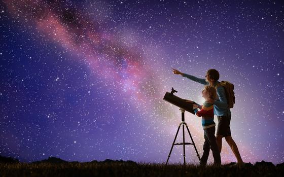 Photo Of  Parent and kid watch night sky with milky way. 