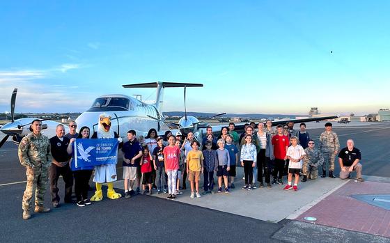 Photo Of Group photo in front of plane