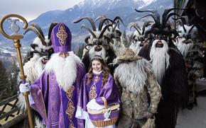 Costumed procession of St. Nicholas, an angel and kramus in a mountainous region, Austria, Salzburg. High quality photo