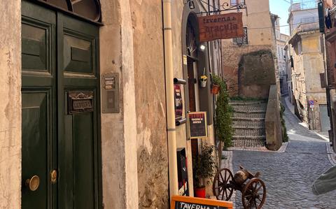 Photo Of colorful street view of the door to the restaurant Taverna di Dracula 