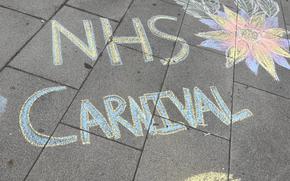 “NHS Carnival” written in chalk on sidewalk