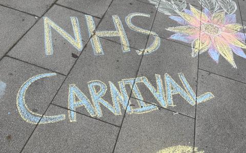Photo Of “NHS Carnival” written in chalk on sidewalk