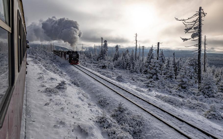 Harz Mountain Train traveling through snowy landscapes to Brocken Peak in winter.