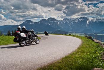 Motorbikes on the road in mountains with Alps in background Salzkammergut,Austria