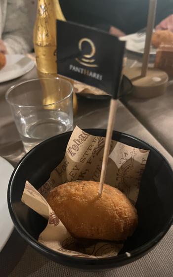 A fried rice ball in a cute dish with a flag to indicate it’s GF stuck in it. 