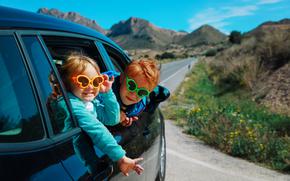 cute boy and girl enjoy travel by car in mountains, family vacation